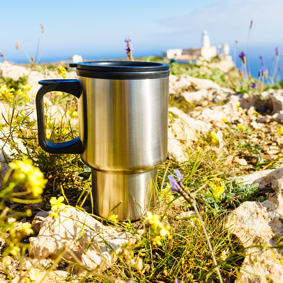 A perfect morning for coffee in a to go mug. Beautiful Rhode Island shore and lighthouse in the distance.