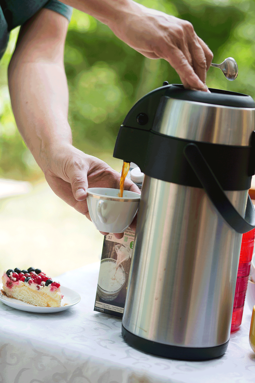 Someone getting a cup of coffee from a dispenser